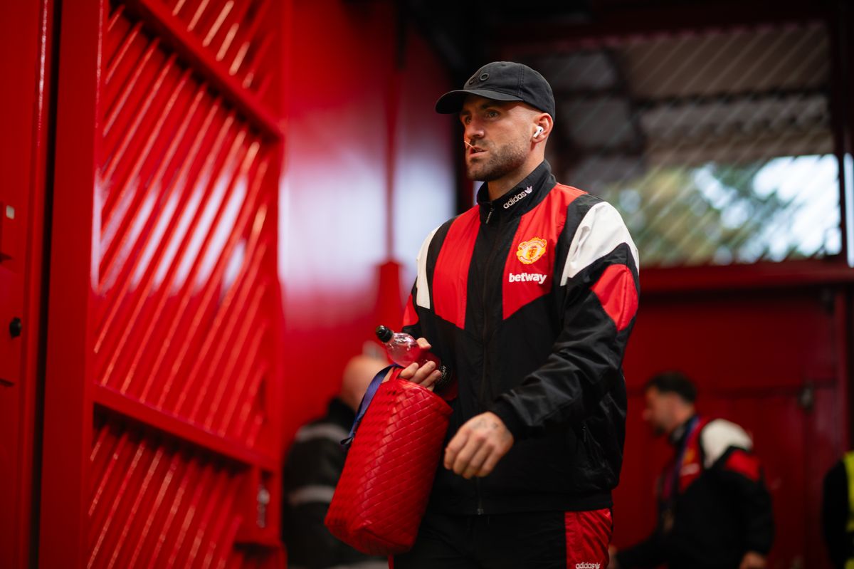 Luke Shaw during a Manchester United match, appearing focused on the field