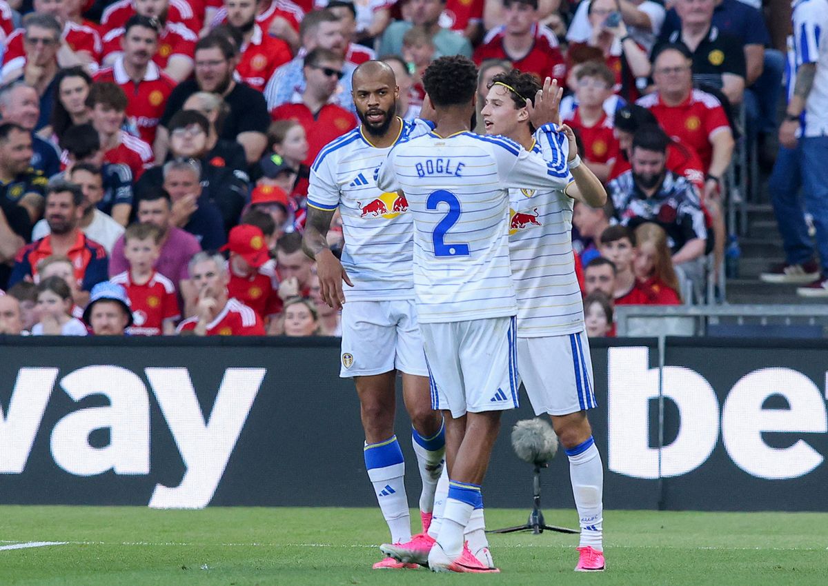 Manchester United player attempts a shot as Leeds defenders close in during the match