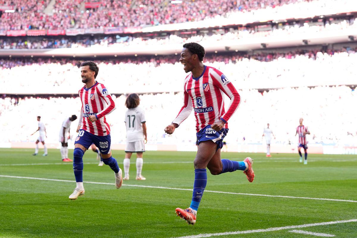 Real Madrid and Atletico Madrid players compete in a tense moment during the derby match