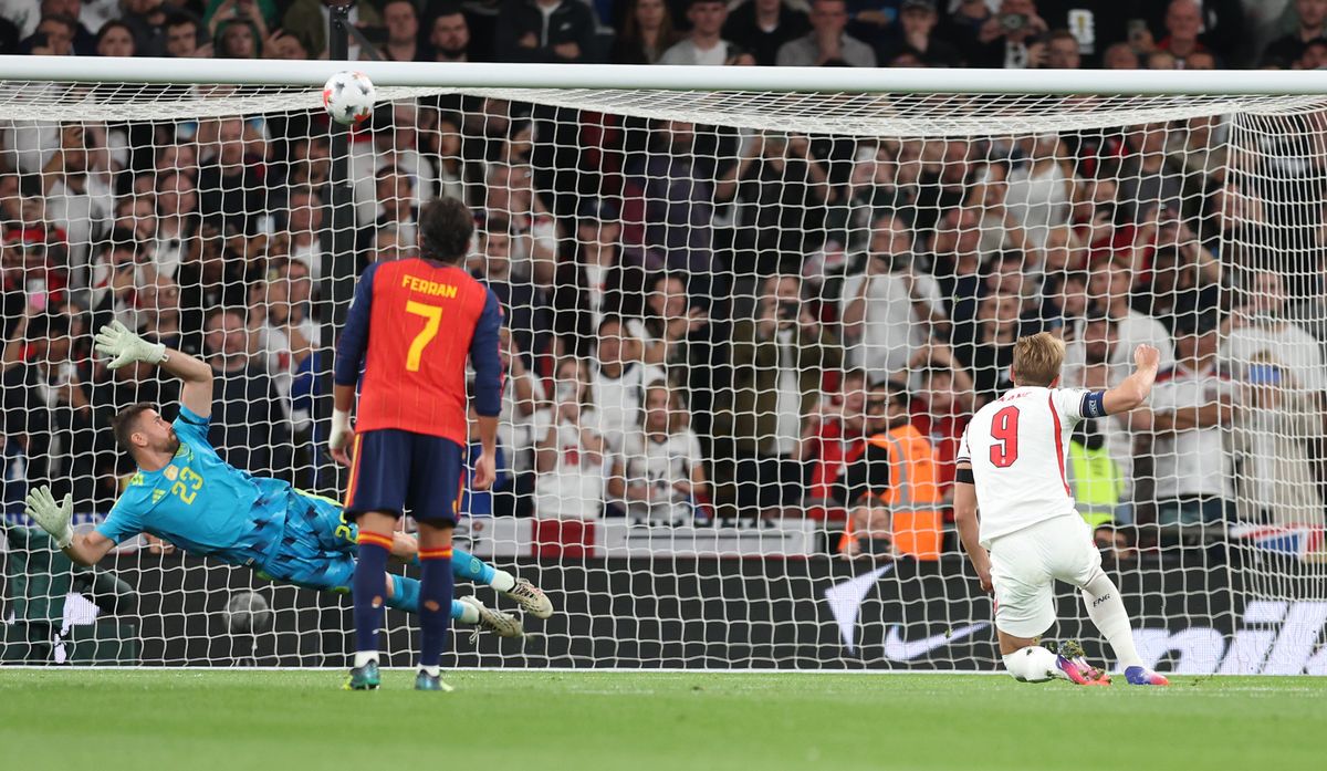 England defender under pressure from Spain forward during match